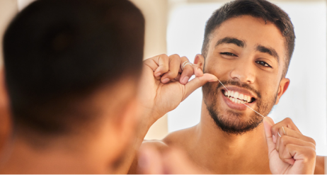 hombre usando hilo dental